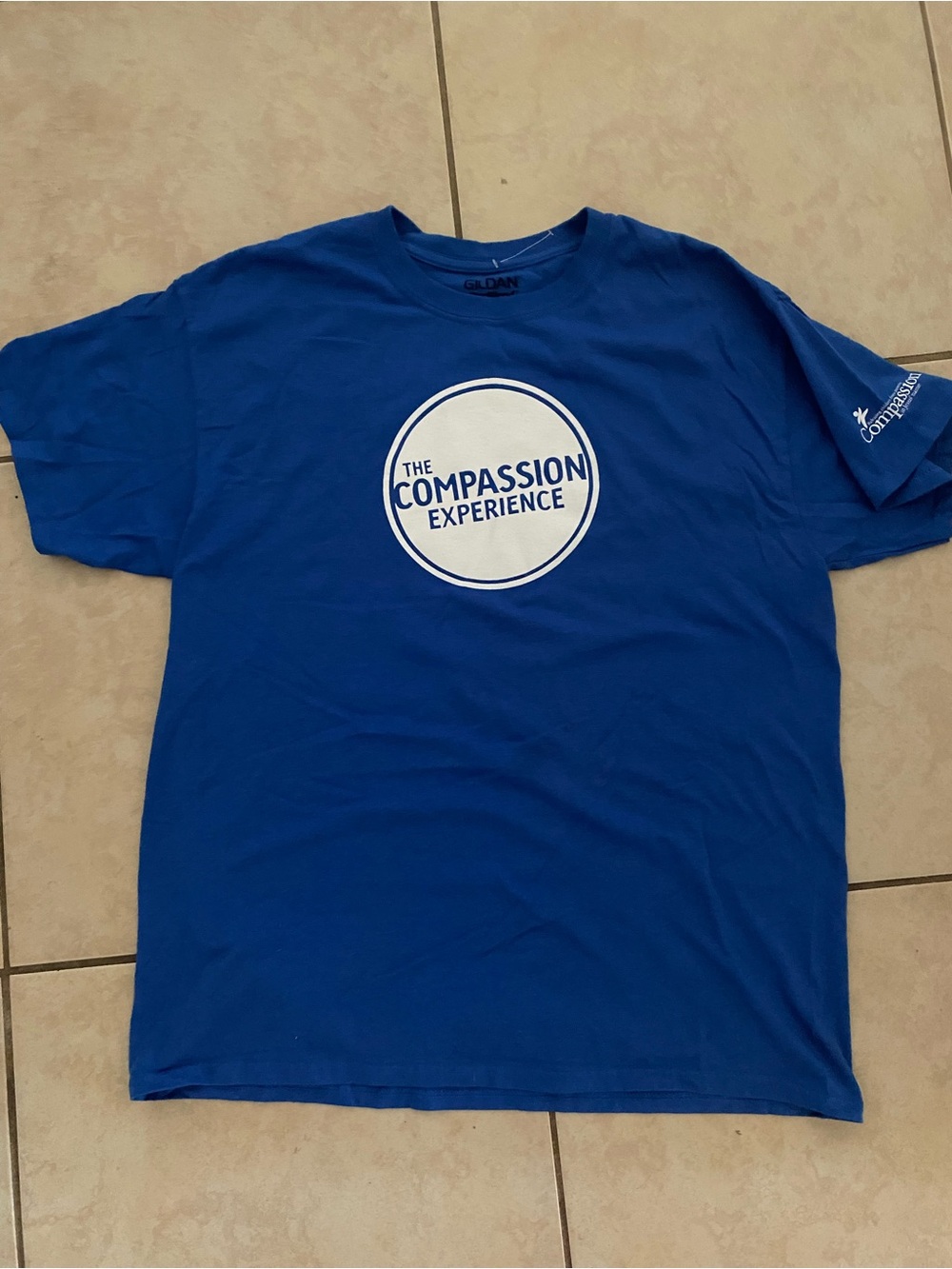 "The Compassion Experience" movement blue tee to end children’s poverty L